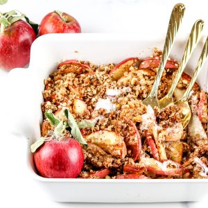 Image of apple crisp in a baking dish with forks.