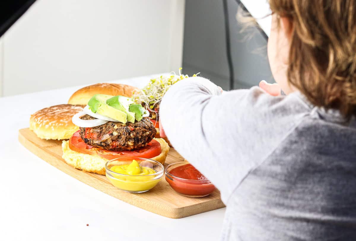 Child eating burger during food photography shoot. 