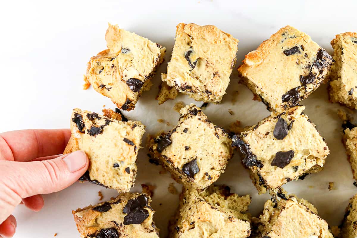 Image of hand grabbing a cookie dough bar.