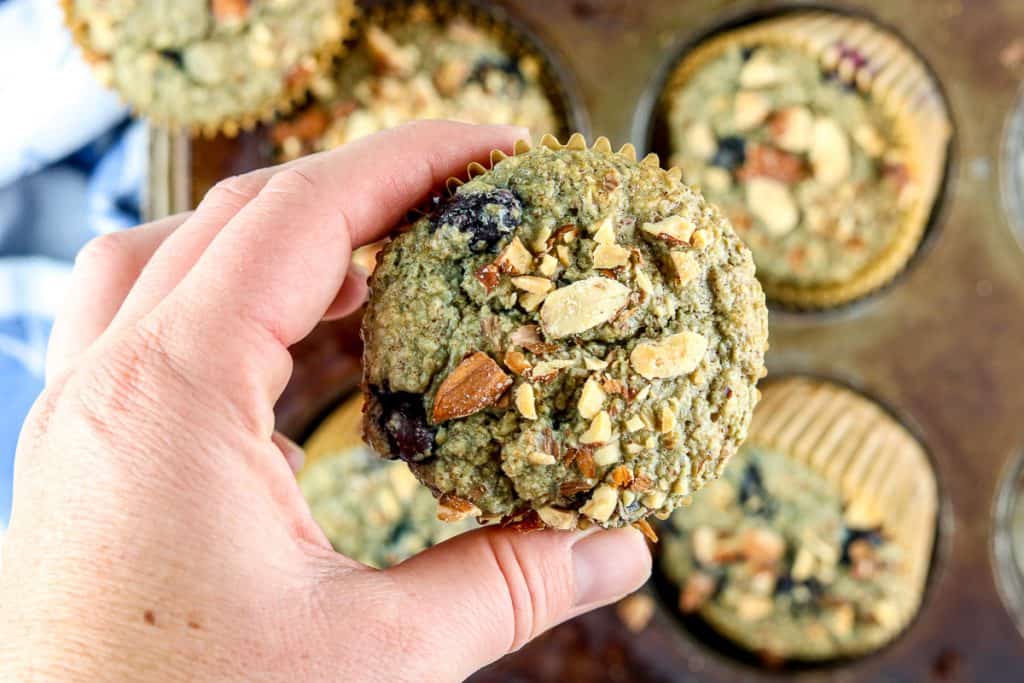 Holding a blueberry muffin up close.