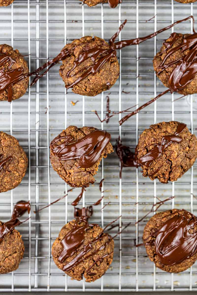 Baked cookies on silver baking sheet with chocolate glaze over the top.