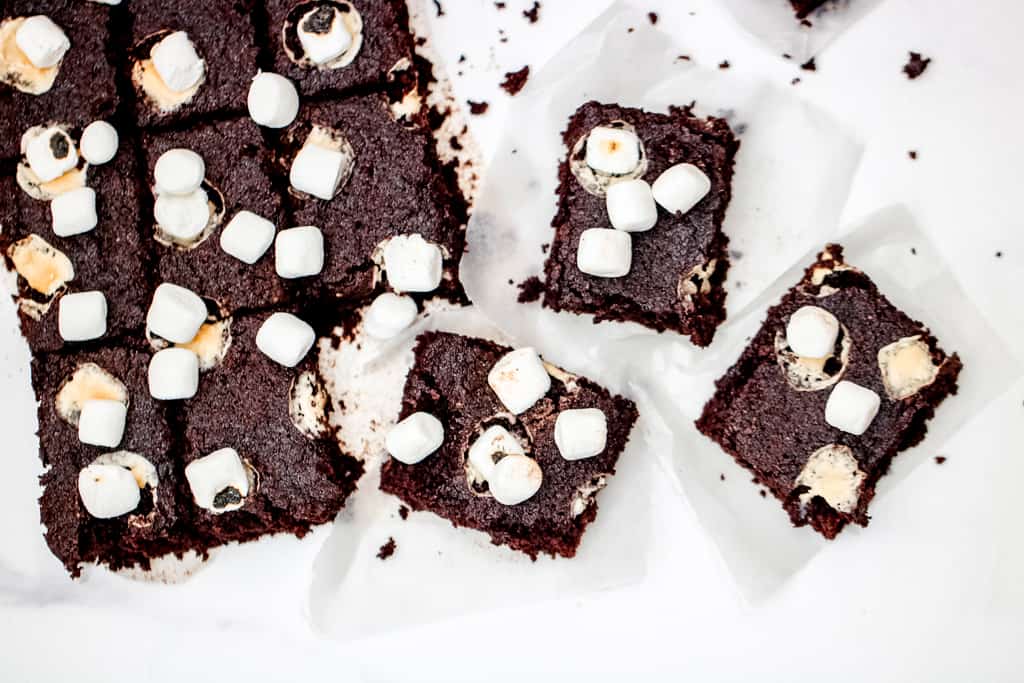 Hot Chocolate Cake Bars - A gluten free holiday or anytime treat the entire crowd will enjoy! Lightened up with half the sugar of a traditional cake bar, this recipe is sure to satisfy a sweet tooth, healthfully! #glutenfreetreats #hotchococolatebars #hotcocoabars #healthyholidaytreats #cookiesforsanta