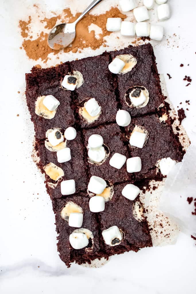 Hot Chocolate Cake Bars - A gluten free holiday or anytime treat the entire crowd will enjoy! Lightened up with half the sugar of a traditional cake bar, this recipe is sure to satisfy a sweet tooth, healthfully! #glutenfreetreats #hotchococolatebars #hotcocoabars #healthyholidaytreats #cookiesforsanta