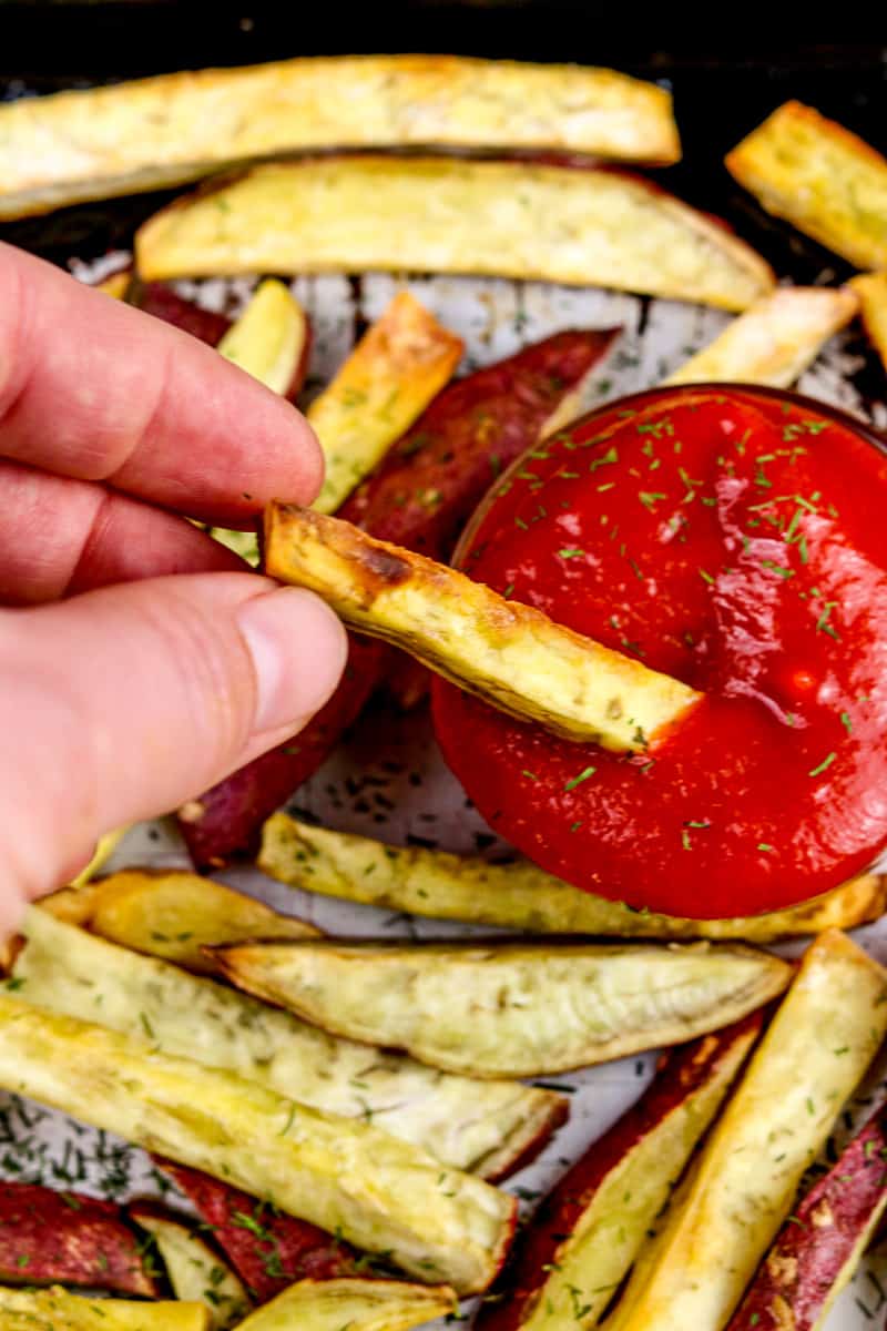 Image of fry dipping into ketchup.