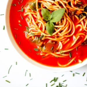 Tomato Soup Pasta with Kale is a simple, vegan dish that the entire family can enjoy. Make It from scratch or simple swap some time with using a canned soup. Either way, the end product is delicious! You'll also find suggestions to modify for a gluten-free diet and high protein soup. #tomatosoup #healthytomatosoup #vegansouprecipes