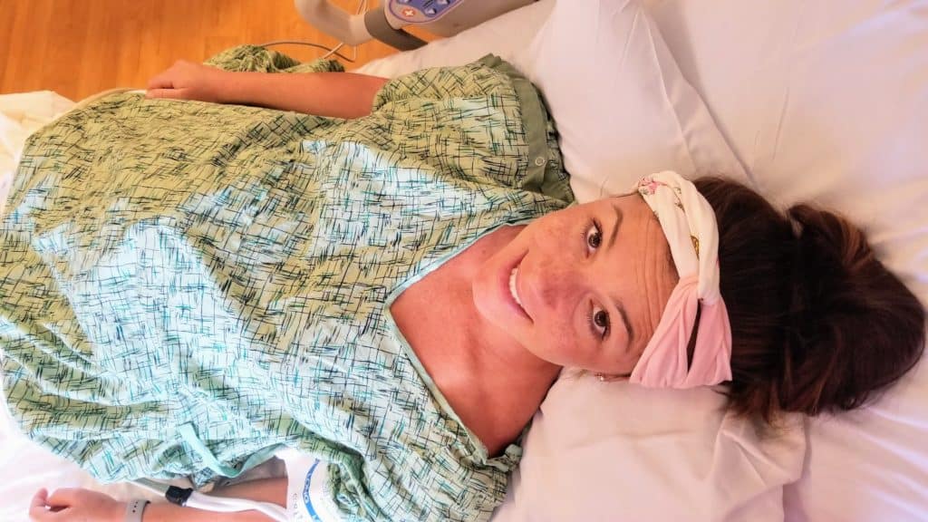 Pregnant woman lying in labor bed after induction. 