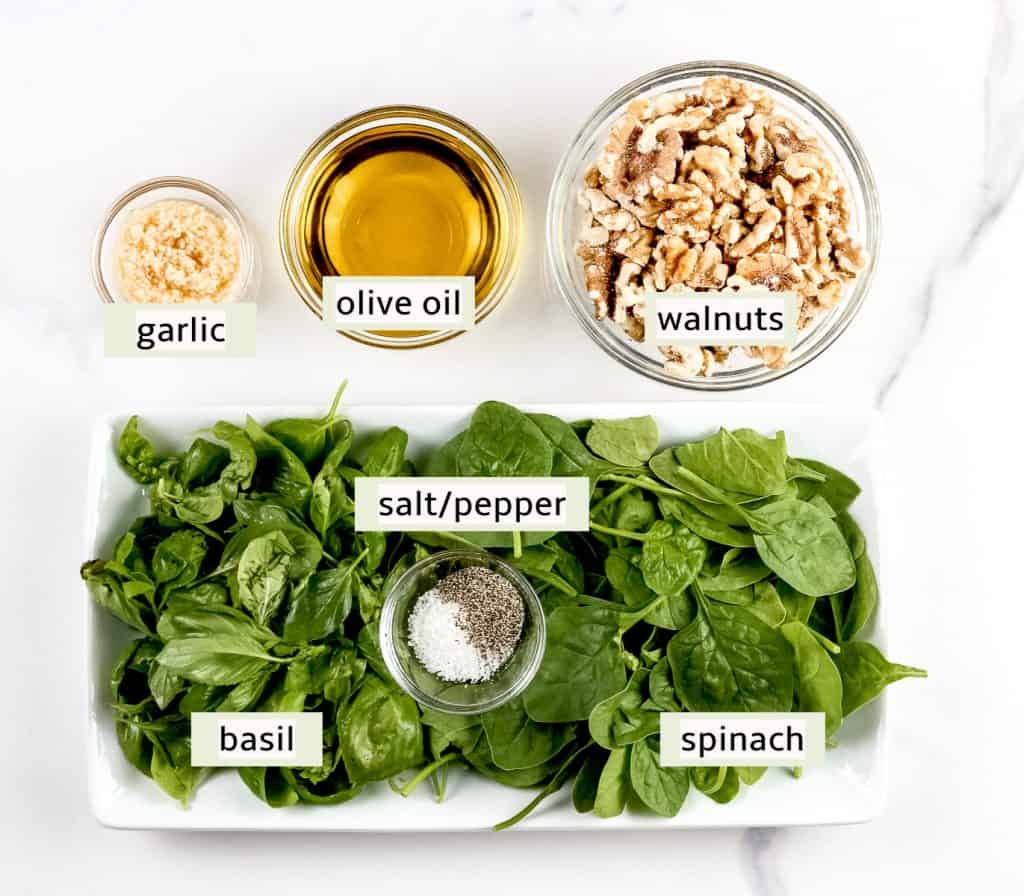 Image of ingredients needed to make walnut pesto sauce.