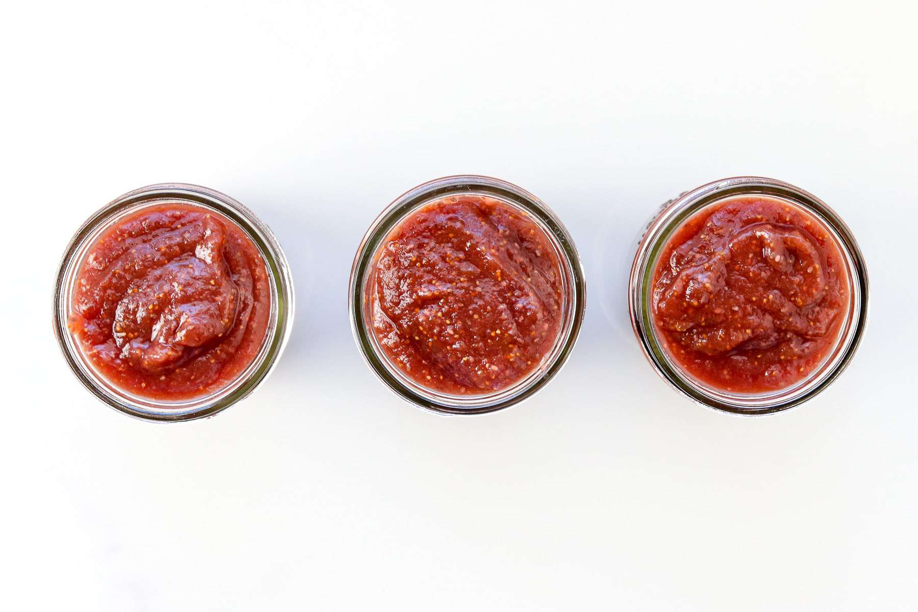 Image of 3 jars of homemade jam in a row. 