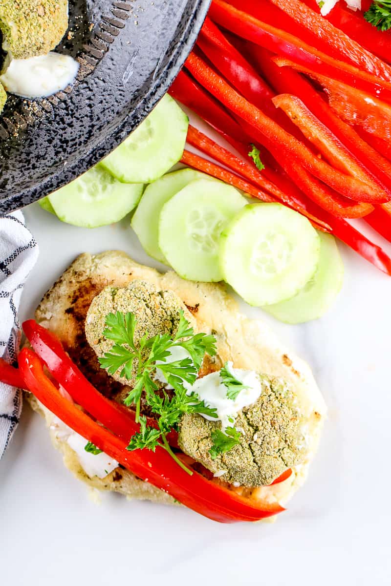 Image of plated falafel with peppers.