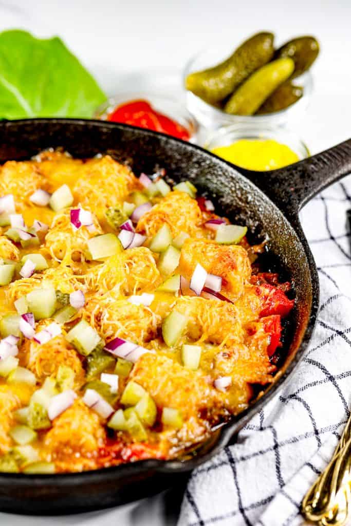 Picture of cheeseburger tater tot casserole in a skillet.