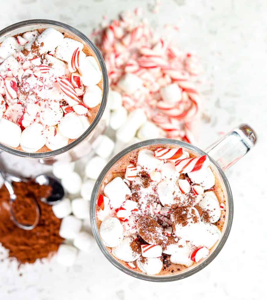Peppermint candy canes on top of hot cocoa.