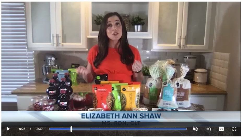Still image of spokesperson on TV screen talking about eggs with blue chevron text.