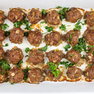 Baby meatballs lined in a white 9x13 inch pan.