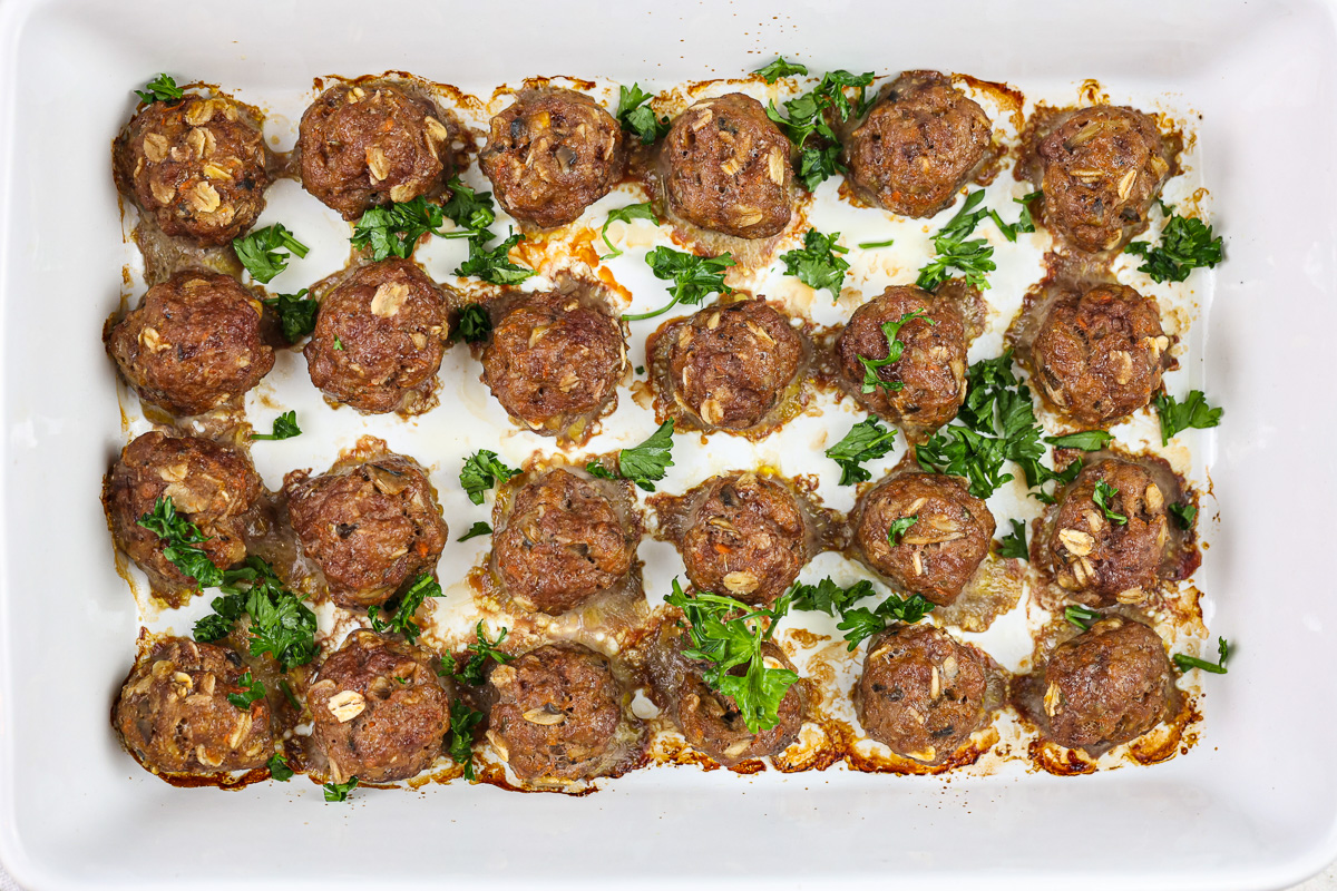 Baby meatballs lined in a white 9x13 inch pan.