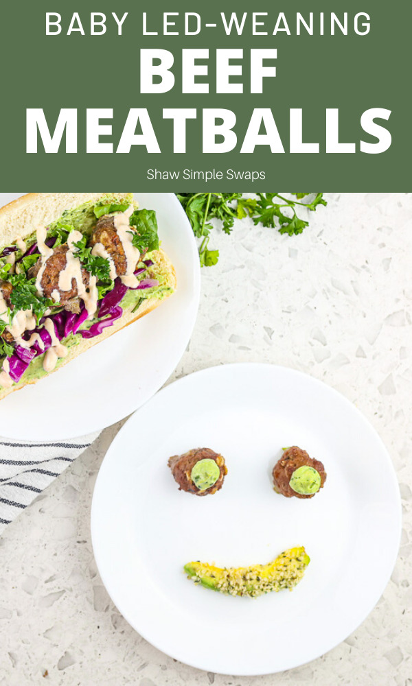 Pinterest image with green box on top with text overlay reading Beef Meatballs, the bottom half is a white plate with two meatballs covered in green sauce for eyes, and a slice of avocado for a mouth to make smiley face.