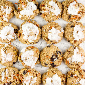 Picture of white backdrop with carrot cake cookies staggered on top.