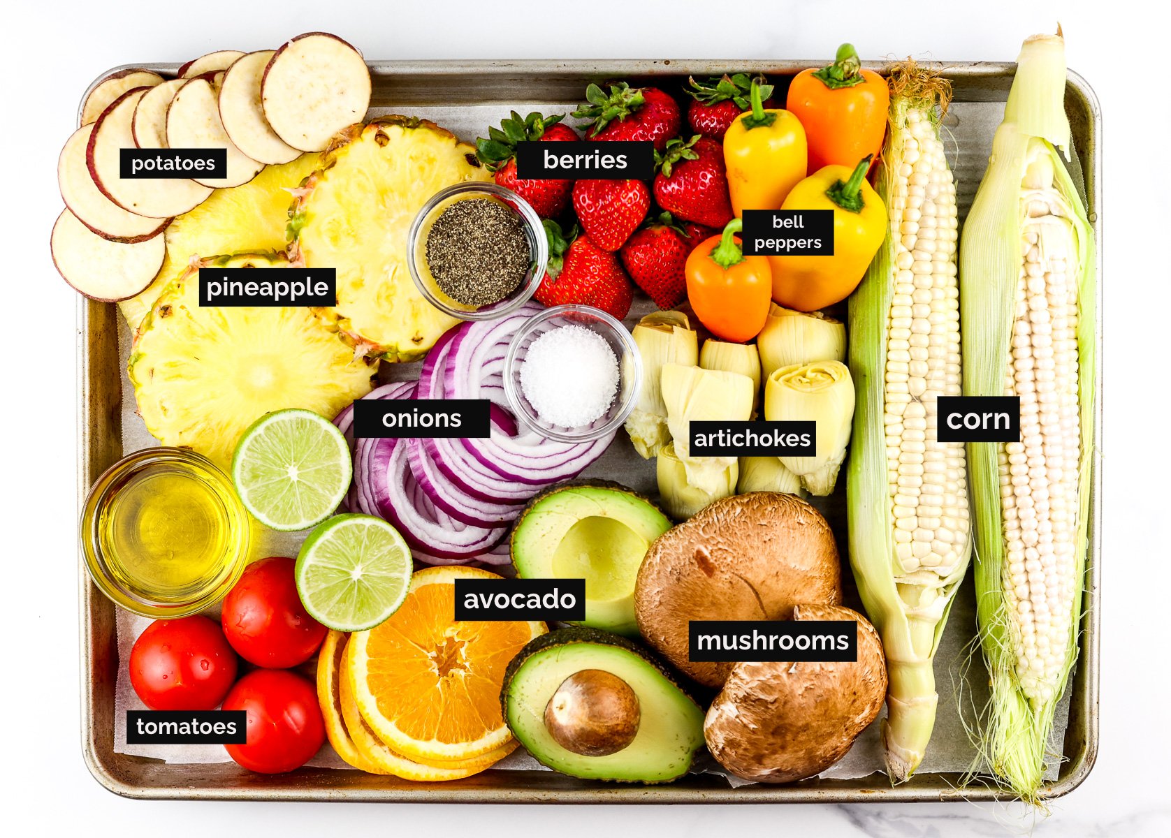 Baking sheet filled with a variety of produce.