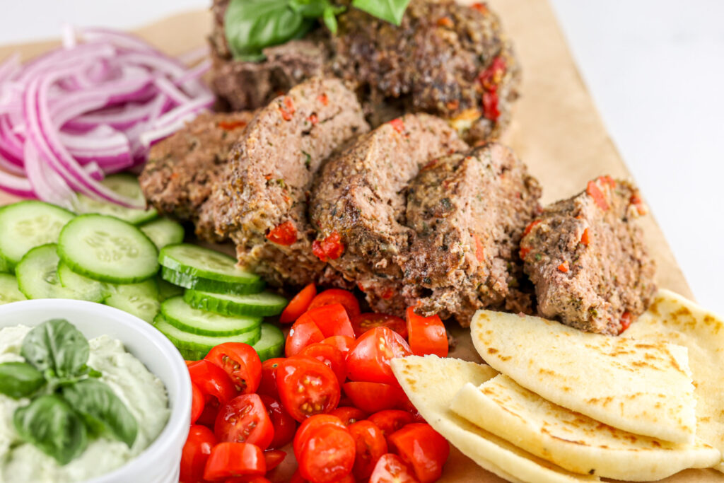 Air fryer meatloaf sliced thin with gyro toppings.