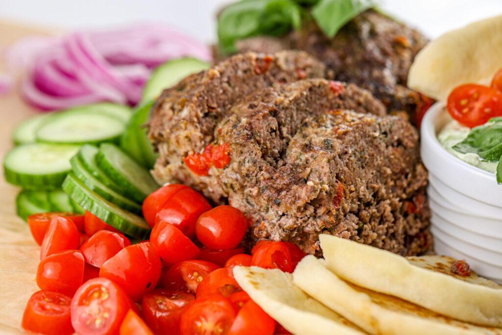 Air fryer meatloaf sliced thin with gyro toppings.