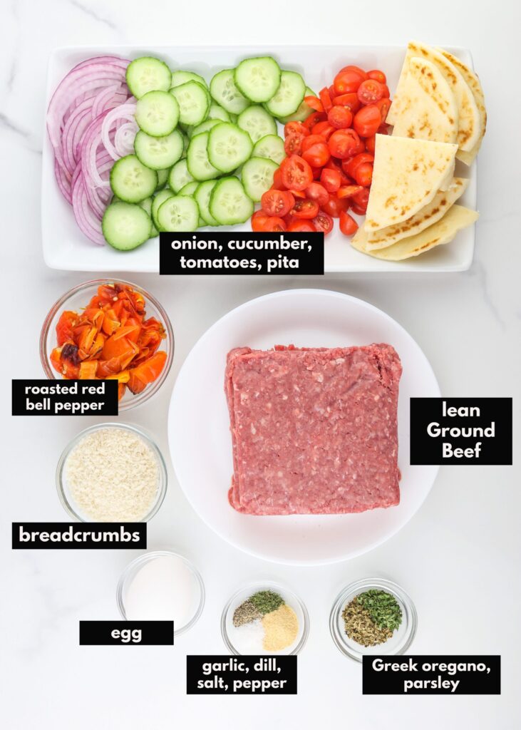 White marble tile with ground beef and ingredients to make meatloaf separated out.