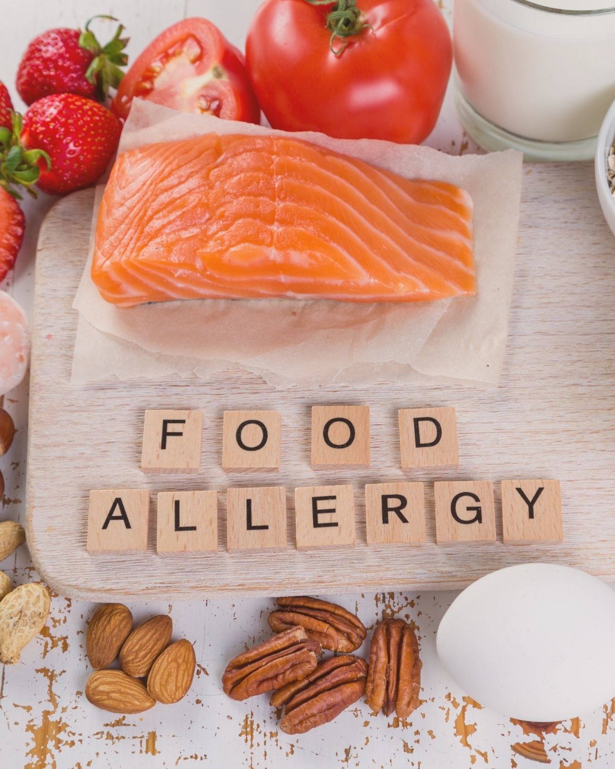 White backdrop with allergen foods on it.