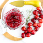 White backdrop with instant pot cranberry jam styled.