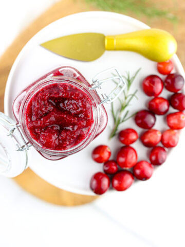 White backdrop with instant pot cranberry jam styled.