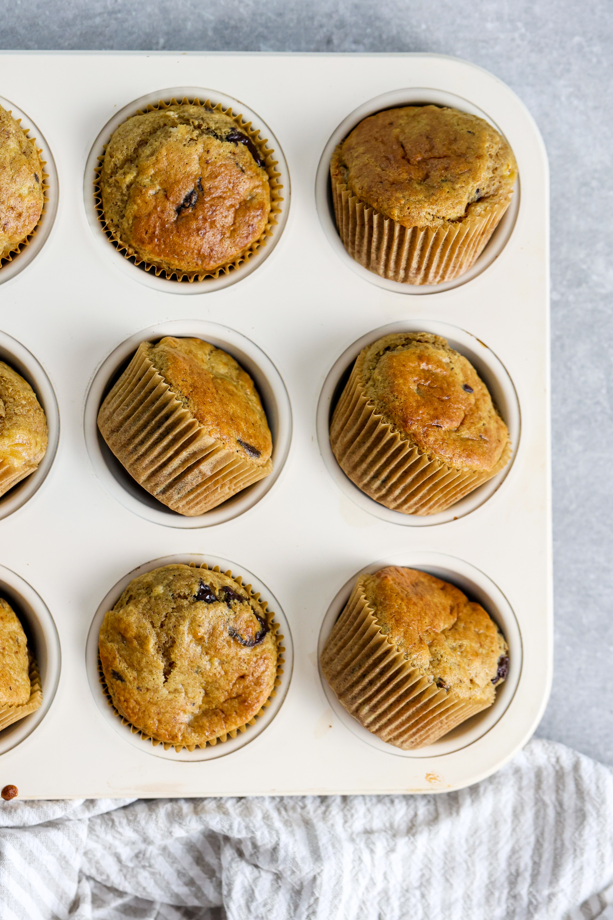 Muffins in muffin tin with grey background for food photography styling.